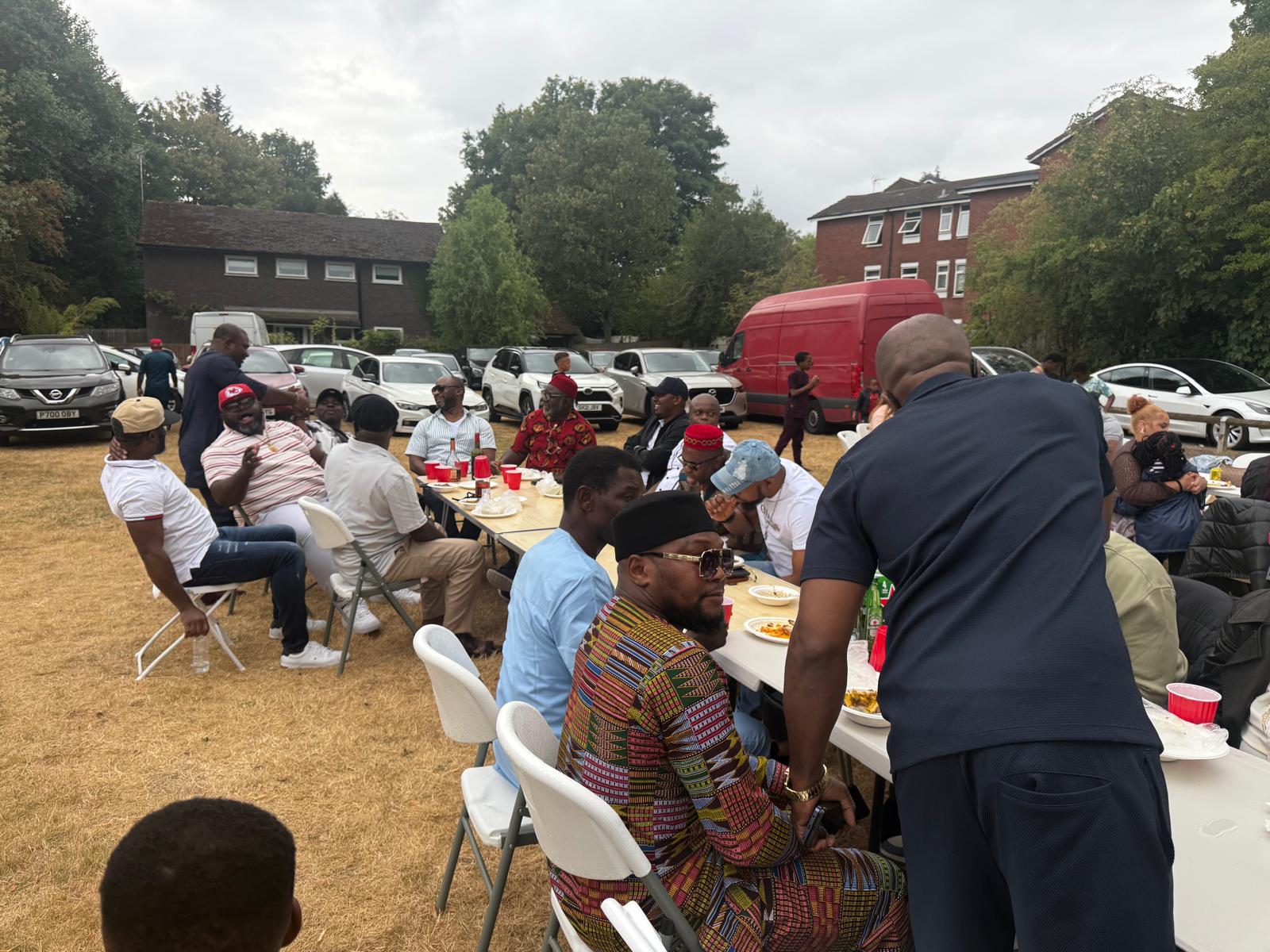 Long tables of AUF members at the outdoor summer gathering