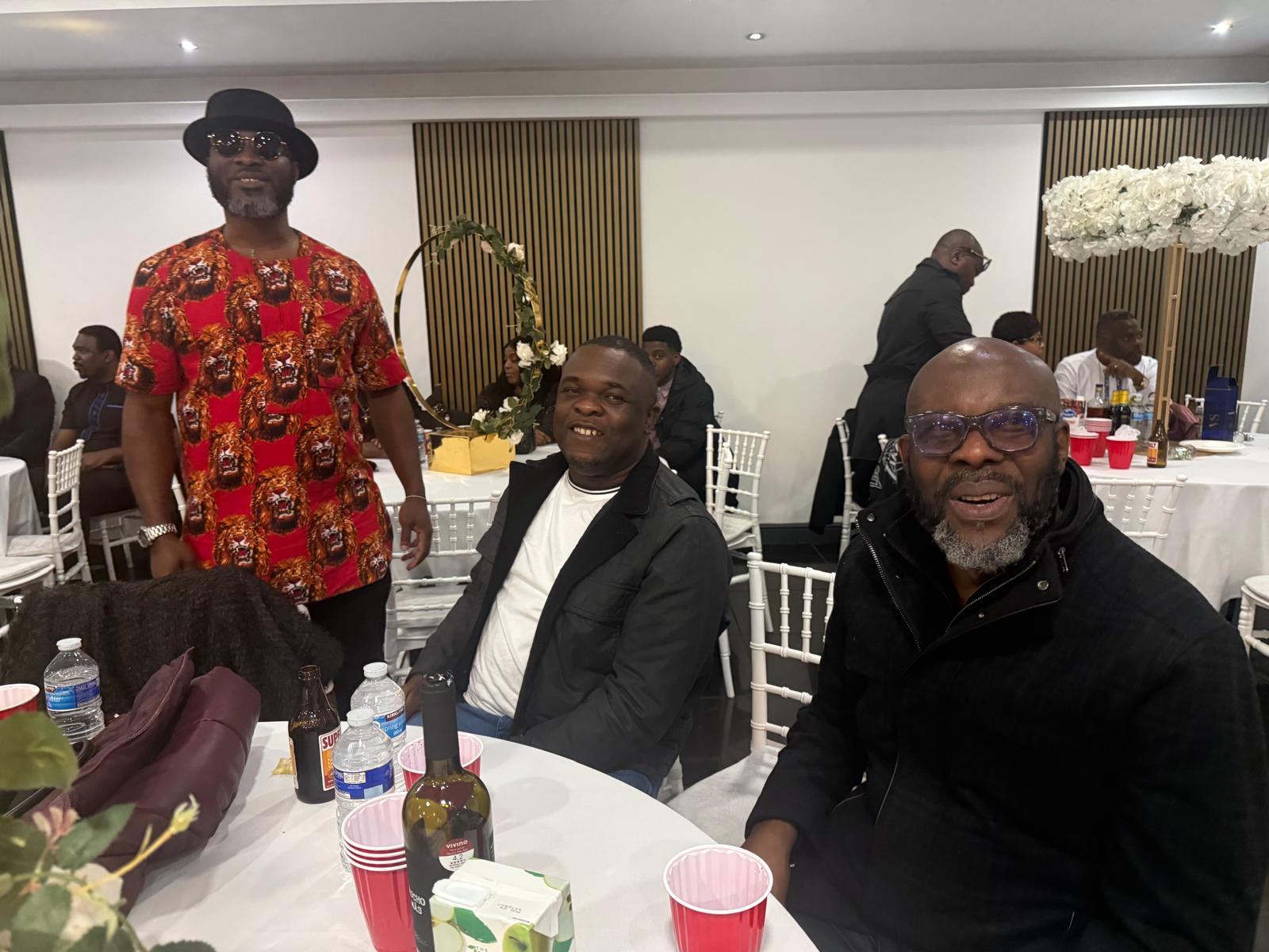 Members in traditional attire relaxing at the AUF party table