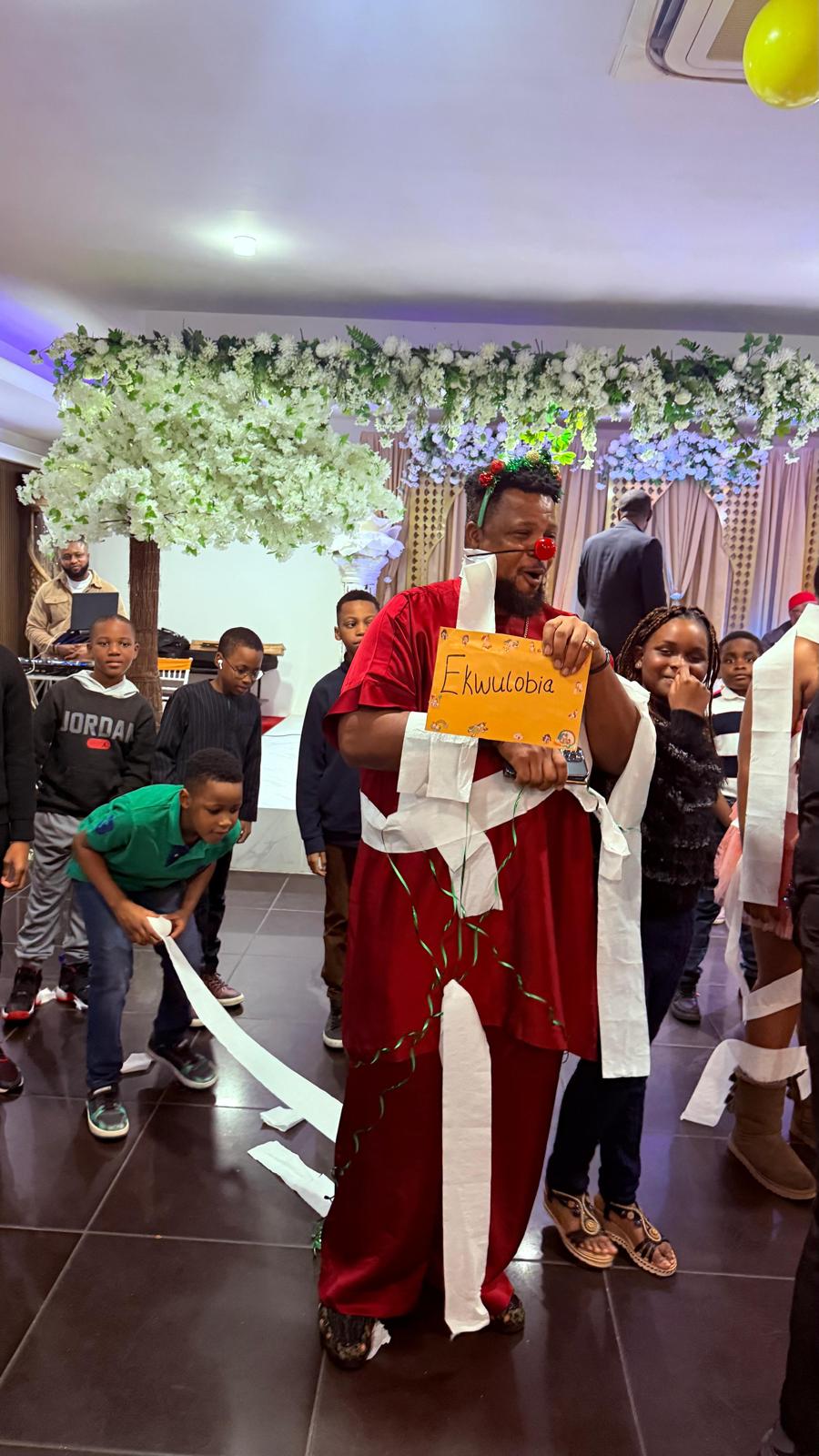 A member holding the Ekwulobia sign during the AUF party games