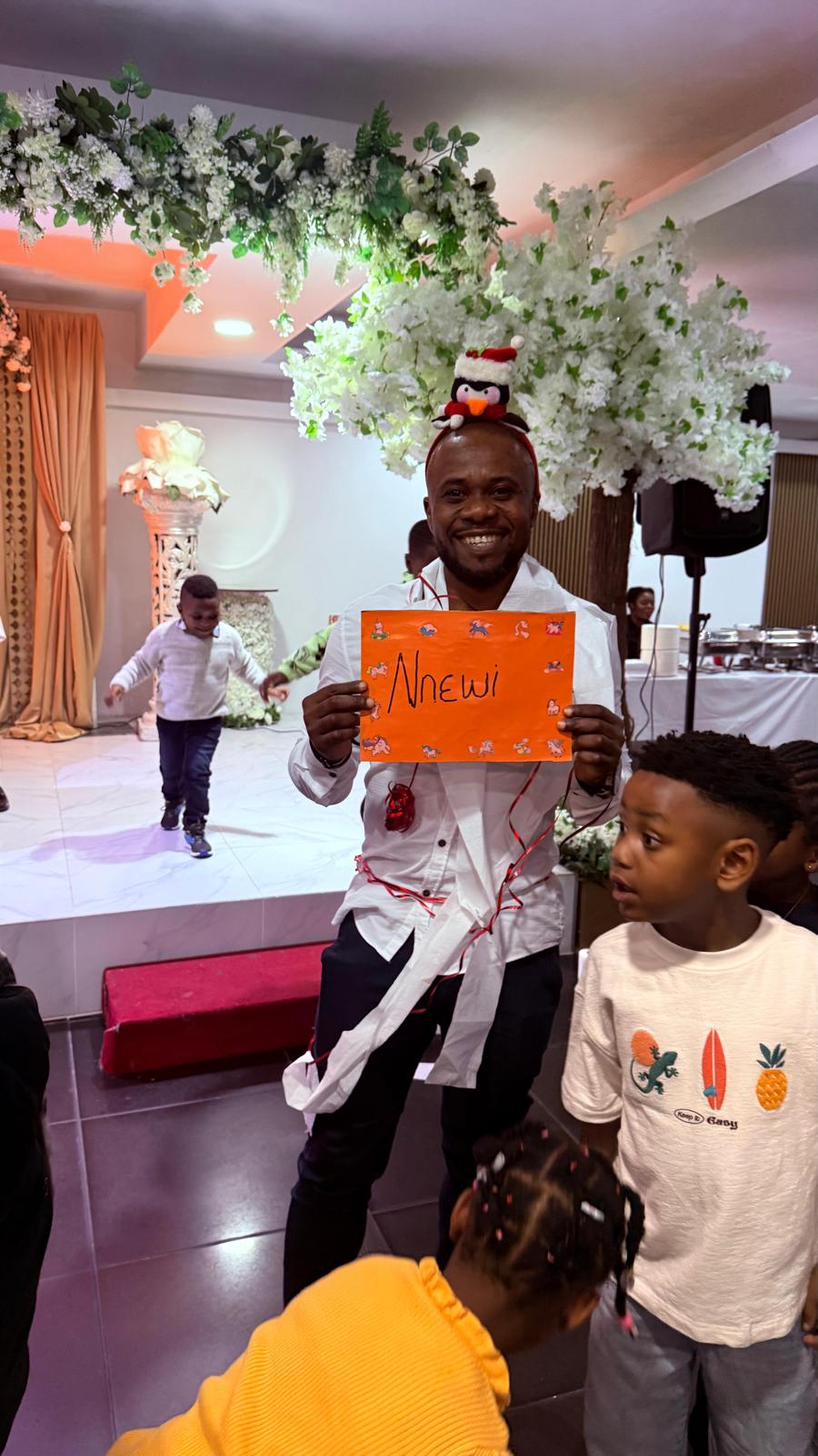 A member holding the Nnewi town sign during the AUF party games